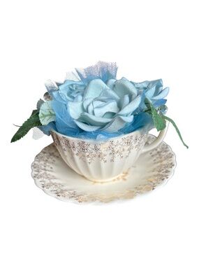 American Limoges vintage Teacup and saucer with blue artificial flowers.
